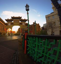 Walkway in city against sky