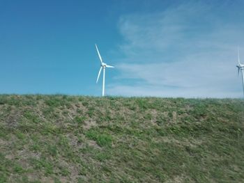 Windmill on field against sky