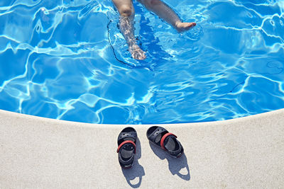 Low section of boy in swimming pool