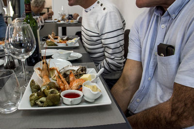 Midsection of man having food on table