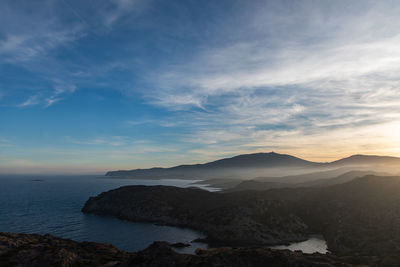 Scenic view of sea and mountains against sky