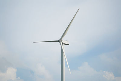 Low angle view of windmill against sky