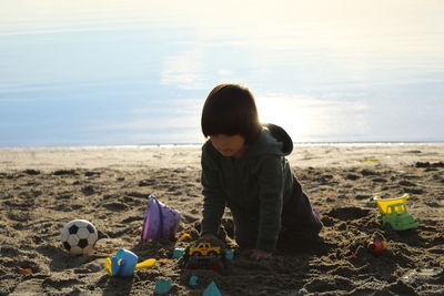 Boy playing with toy on beach