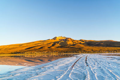 Scenic view of desert against clear sky