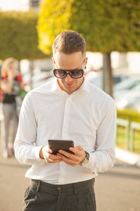 Portrait of young man using mobile phone