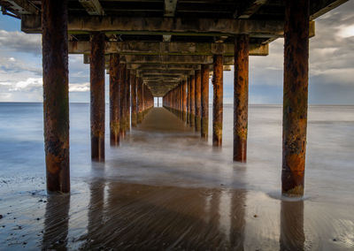 Pier over sea against sky