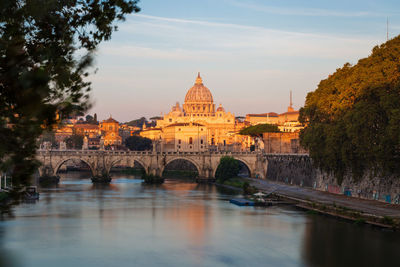 Arch bridge over river against sky