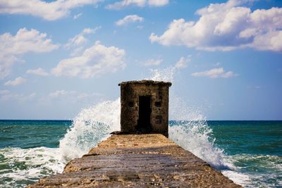 Scenic view of sea against cloudy sky