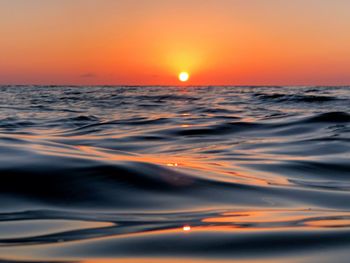 Scenic view of sea against romantic sky at sunset