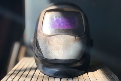 Close-up of old welding helmet on table