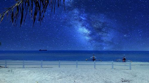 Scenic view of beach against sky at night