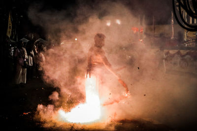 Blurred motion of woman with fire crackers at night