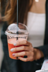 Close-up of woman holding drink