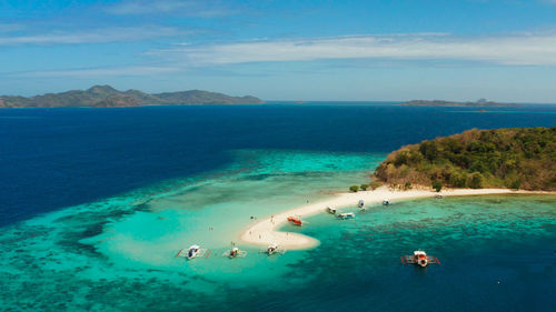 Seascape tropical island with sand bar, turquoise water and coral reef. ditaytayan, palawan