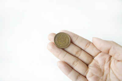 Close-up of hand holding coins