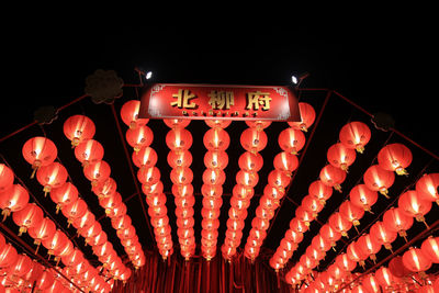 Low angle view of illuminated lighting equipment in darkroom