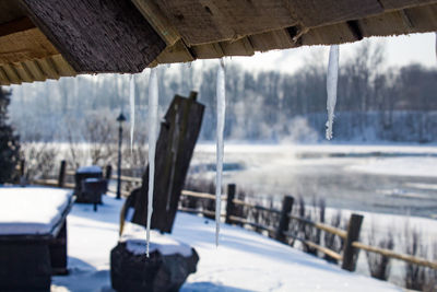 Frozen lake against built structure during winter