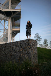 Woman standing by steps