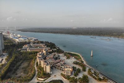 High angle view of sea and buildings against sky