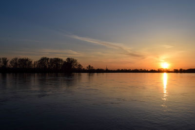 Scenic view of lake against sky during sunset