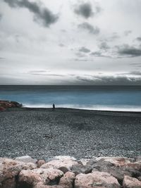 Woman at sea against sky