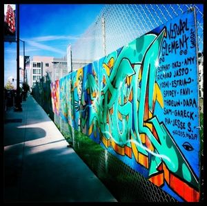 Graffiti on wall against blue sky