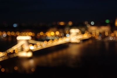 Defocused image of illuminated city at night