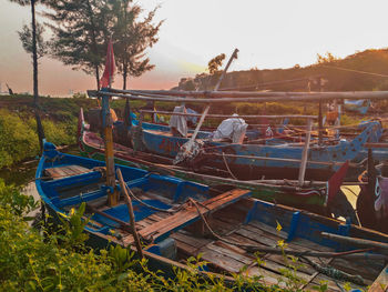 Panoramic view of boats moored at beach against sky