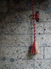Close-up of red decoration hanging against wall