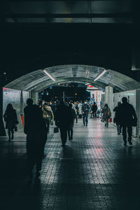 Group of people walking on railroad station platform