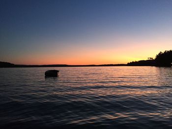 Scenic view of sea against orange sky