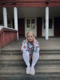 Sitting alone on a wooden terrace