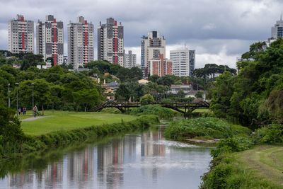 Scenic view of lake by buildings against sky