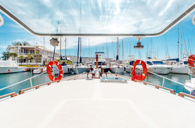 Boats sailing in sea against sky