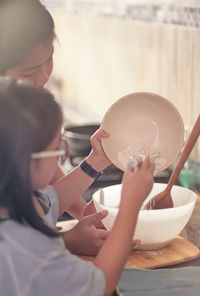 Mother and daughter preparing food at home