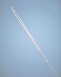 Low angle view of vapor trail against blue sky