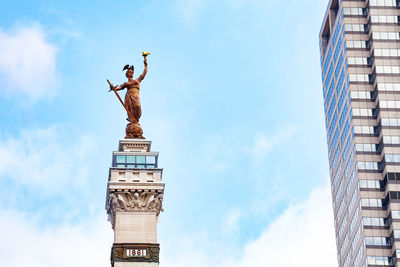 Low angle view of statue against cloudy sky