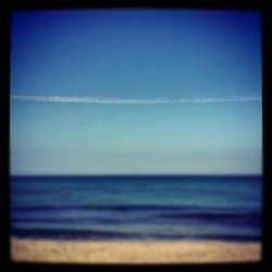 Scenic view of sea against blue sky