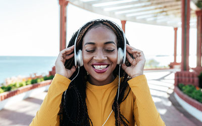 Portrait of smiling young woman using smart phone