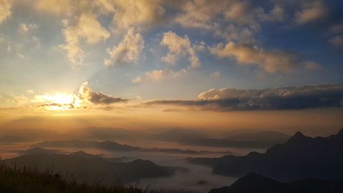 Scenic view of silhouette mountains against sky at sunset