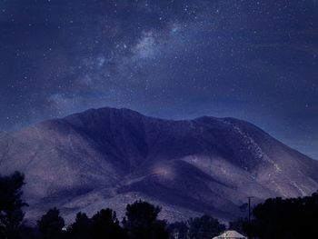 Scenic view of mountains against sky at night
