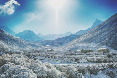 Scenic view of snow covered mountains against sky
