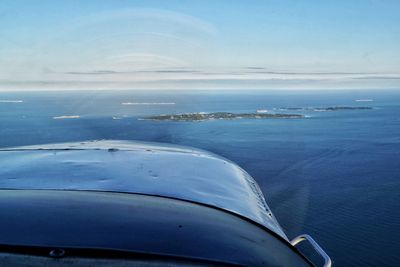 Pov out of airplane flying towards matinicus island over sea against sky 