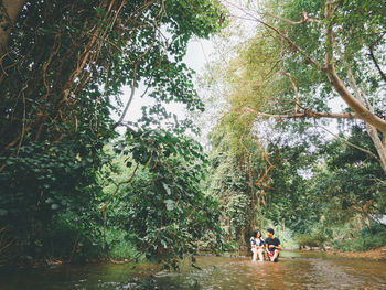 People by river in forest