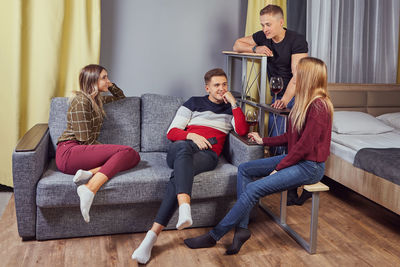 People sitting on sofa at home