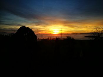 Scenic view of silhouette trees against sky during sunset