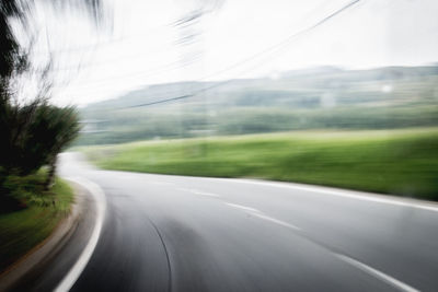 Blurred motion of road seen through car windshield