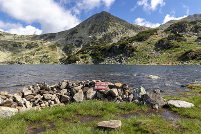 Scenic view of lake and mountains against sky