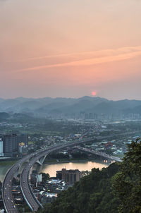 High angle view of cityscape against sky during sunset