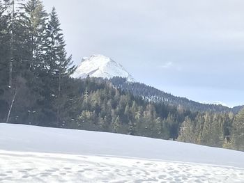 Snow covered landscape against sky